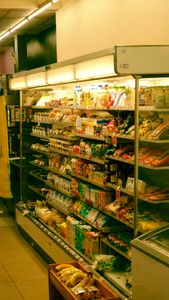 Wide variety of grocery items displayed on shelves in a supermarket in Ho Chi Minh City, Vietnam.